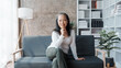 © Phushutter - Happy asian mature woman people relaxing while sitting on a couch