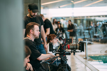 Wall Mural - Director of photography with a camera in his hands on the set. Professional videographer at work on filming a movie