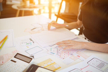 Wall Mural - mobile application developers are designing a ux ui system to make the display on the phone screen g