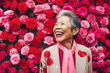© Trinette Reed - Happy stylish senior Asian woman with rose colored glasses.