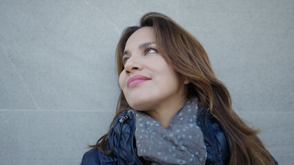 Canvas Print - Young beautiful hispanic woman smiling confident looking to the sky over isolated white background