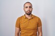 © Krakenimages.com - Hispanic man with beard standing over white background depressed and worry for distress, crying angry and afraid. sad expression.