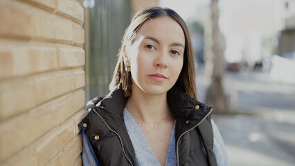 Canvas Print - Young beautiful hispanic woman standing with serious expression at street