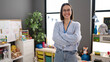 © Krakenimages.com - Young beautiful hispanic woman teacher smiling confident standing with arms crossed gesture at kindergarten