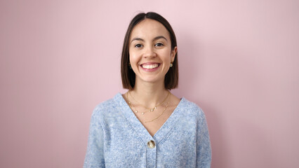 Canvas Print - Young beautiful hispanic woman smiling confident standing over isolated pink background