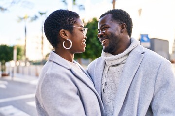 Poster - Man and woman couple smiling confident standing together at street