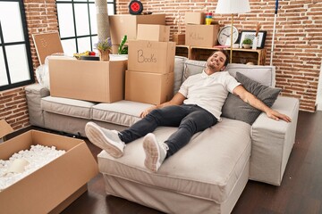 Sticker - Young hispanic man relaxed sitting on sofa at new home