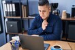 © Krakenimages.com - Young latin man business worker using laptop with doubt expression at office