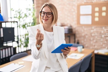 Sticker - Young caucasian woman working at the office wearing glasses doing money gesture with hands, asking for salary payment, millionaire business