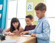 © Krakenimages.com - Group of kids students sitting on table studying at classroom