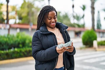 Sticker - African american woman smiling confident counting dollars at street