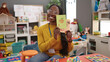 © Krakenimages.com - African woman preschool teacher on a vocabulary lesson at kindergarten