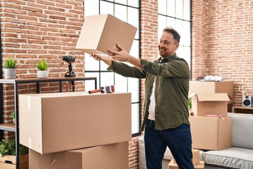 Sticker - Young caucasian man smiling confident holding package at new home