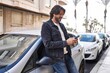 © Krakenimages.com - Middle age man using smartphone leaning on car at street