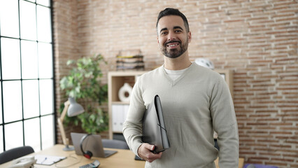 Sticker - Young hispanic man business worker smiling confident holding binder at office