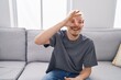 © Krakenimages.com - Young caucasian man wearing virtual reality glasses smiling happy doing ok sign with hand on eye looking through fingers