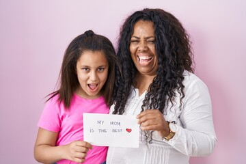 Poster - Mother and young daughter holding my mom is the best banner smiling and laughing hard out loud because funny crazy joke.