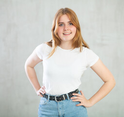 Portrait of young beautiful cute cheerful girl smiling looking at camera over grey background