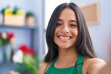 Poster - Young hispanic woman florist make selfie by camera at florist shop