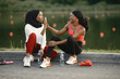 © prostooleh - Two black women giving a high five to each other after doing workout