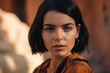 © aicandy - striking woman with olive skin, glossy black hair, and a bold gaze, photographed against a warm camel background, generative ai