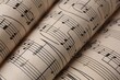 © New Africa - Rolled sheets with music notes as background, closeup
