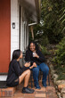 © Austockphoto - Aboriginal parent sitting together with teen on back porch