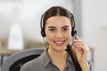 Canvas Print - Hotline operator with headset working in office