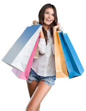 Young Woman With Shopping Bags On Blurrred Background