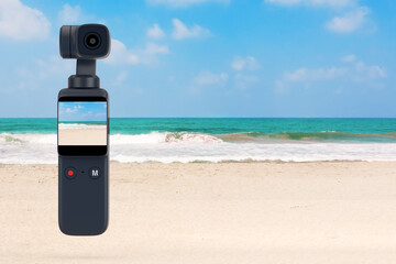 Leinwandbilder - Pocket Handheld Gimbal Action Camera on an Ocean or Sea Summer Beach. 3d Rendering