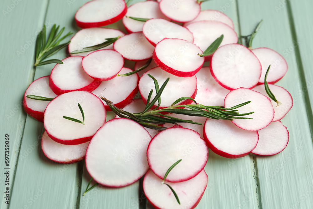 Slices of fresh radish on wooden table