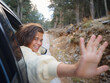 © YURII Seleznov - Woman on road trip traveling by rental car . adventure lifestyle vacations vibes outdoor sunset Turkey mountains forest, Fethie , Babadag mount. Happy female raising her hand out of the car window.