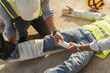 © ME Image - First aid worker accident in construction site, Builder accident fall scaffolding to concrete floor.