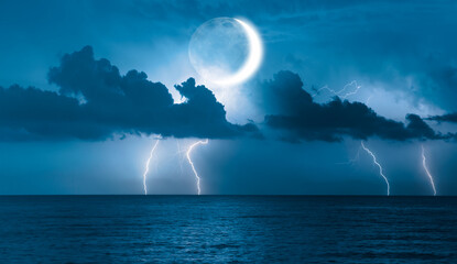 Wall Mural - Night sky with lightning on crescent moon in the clouds on the fore ground calm blue sea 