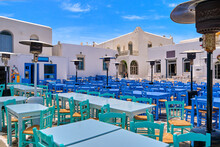 Colorful Tables And Chairs Of Greek Outdoor Cafes And Restaurants On