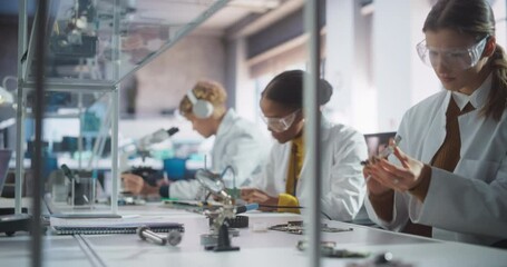 Leinwandbilder - Diverse Team of Multiethnic Young Scientists Passing Internship in a Modern High Tech Laboratory. Students Working in Advanced Lab with Science Equipment. Microchip Design and Electronics Development