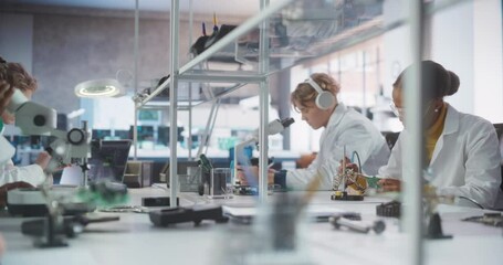 Leinwandbilder - Modern Science Research Laboratory in University: Diverse Young Scientists in White Coats Using Microscope, Soldering Circuit Boards and Microchips for a Technology Project in School