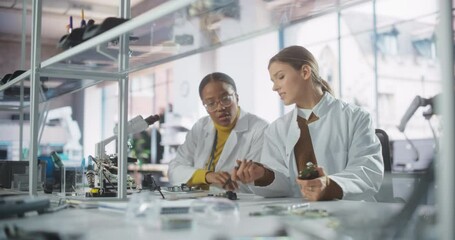 Leinwandbilder - Modern Science Research Laboratory in University: Diverse Young Scientists in White Coats Using Microscopes, Discussing Assignment for a Technology Project in School