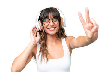 Wall Mural - Young caucasian woman over isolated background listening music and singing