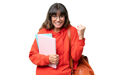 Young student caucasian woman over isolated background celebrating a victory in winner position