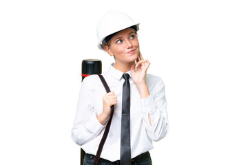 Wall Mural - Young architect caucasian woman with helmet and holding blueprints over isolated background thinking an idea