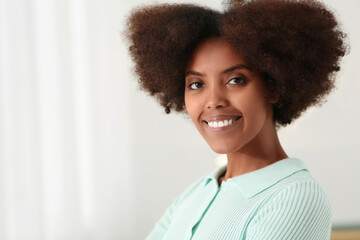 Wall Mural - Portrait of smiling African American woman at home. Space for text