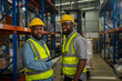 © visoot - Warehouse worker checking packages on shelf in a large store,Logistics worker storing package boxes.