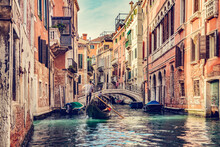 Canal In Venice, Italy With Gondolier Rowing Gondola