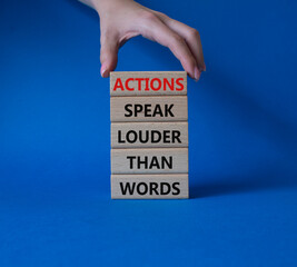 Wall Mural - Actions speak louder than Words symbol. Wooden blocks with words Actions speak louder than Words. Beautiful blue background. Businessman hand. Business and Actions concept. Copy space.