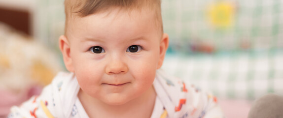 Wall Mural - Portrait of cute baby boy looking at camera. Joy and happiness concept. Love and family emotion