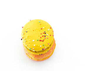 Sweet colorful yummy macarons isolated on white background. Tasty colourful macaroons. Two multi-colored orange and yellow macaroons. French pastry made from egg whites.