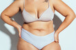 © oneinchpunch - Plus size woman posing in studio in lingerie