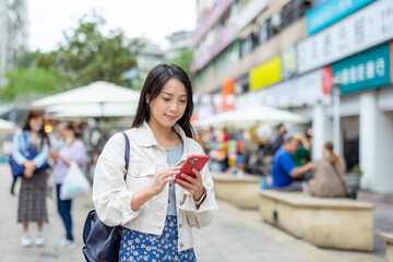 Sticker - Woman use smart phone in the street