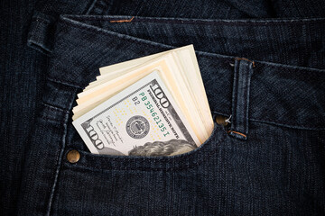 Several 100 us dollar bills in the pocket of jeans close up